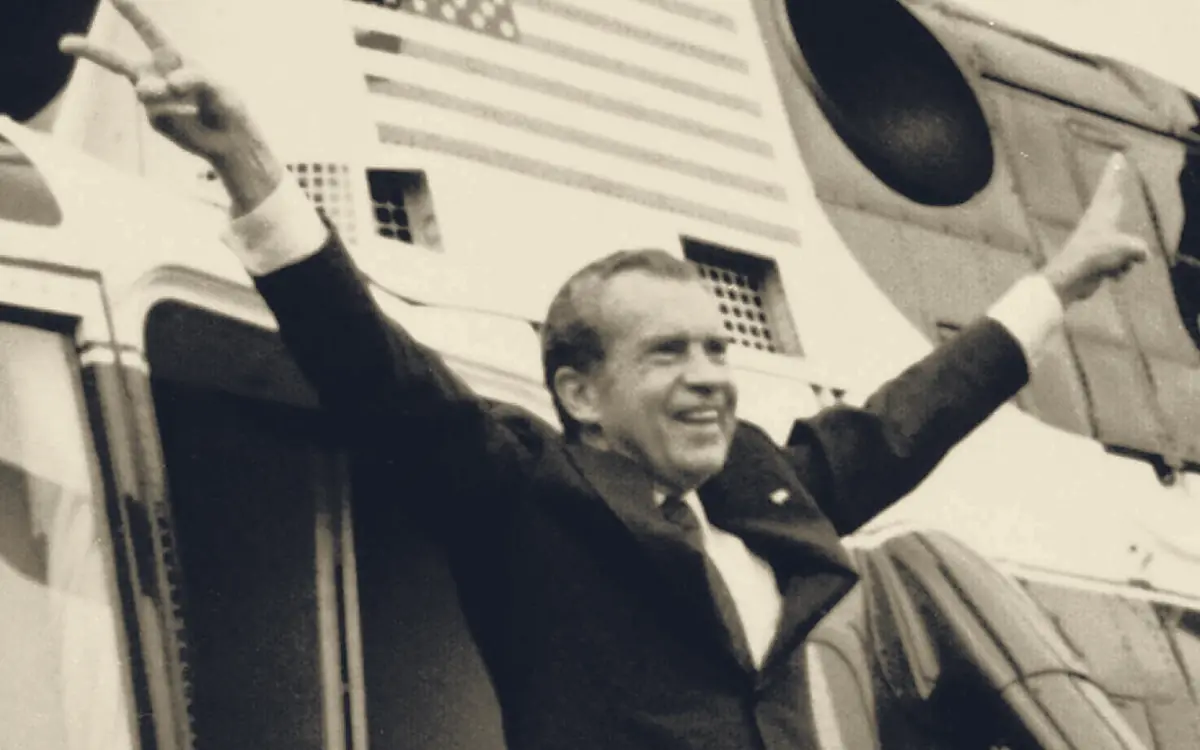 Richard Nixon waving from the steps of the presidential helicopter as he leaves the White House after resigning, August 9, 1974